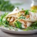 Chicken Caesar Salad Wraps with grilled chicken, romaine lettuce, and parmesan in a tortilla wrap, ready in 30 minutes.