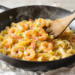 One-pan shrimp scampi with linguine in garlic butter sauce, photographed at a 45-degree angle in natural light.