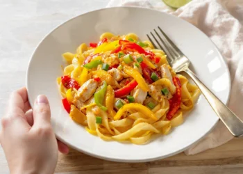 One-pan chicken fajita pasta with bell peppers and onions, creamy and colorful in a skillet.