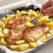 One-pan fish and chips with baked fish fillets and roasted potatoes, lighter and golden in a pan.