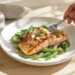One-pan salmon with green beans and toasted almonds, lightly browned and served straight from the pan.