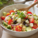Mediterranean quinoa salad with fresh vegetables and herbs, quick and easy vegetarian dish.