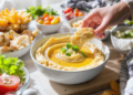 Budget-friendly dips and spreads served with bread and vegetables, quick and easy low-cost meal idea.
