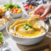 Budget-friendly dips and spreads served with bread and vegetables, quick and easy low-cost meal idea.