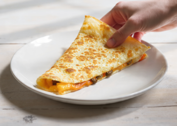 Budget-friendly cheese and vegetable quesadillas cut into slices, quick meal for feeding a crowd.