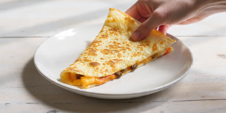 Budget-friendly cheese and vegetable quesadillas cut into slices, quick meal for feeding a crowd.