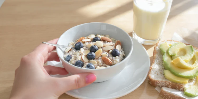 Diabetic-friendly breakfast with eggs, whole grain, berries, and nuts on plate for blood sugar control