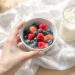 Healthy breakfast bowl with oatmeal, berries, nuts for weight loss on wooden table