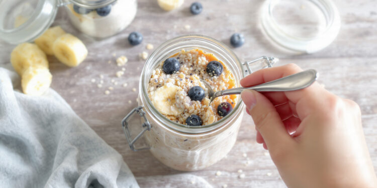 Quick healthy overnight oats with berries and banana in glass jar