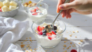 Healthy yogurt parfait breakfast with berries, granola and honey - quick morning meal