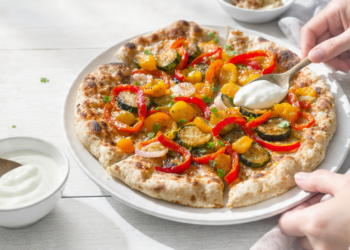Vegetarian naan pizza with roasted vegetables and cheese, quick and easy flatbread meal.