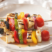 Grilled halloumi and vegetable skewers, quick vegetarian dish with golden cheese and veggies.