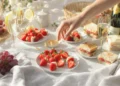 Easy picnic food ideas for two with romantic finger foods, fresh fruit, cheese, and quick snacks on a blanket outdoors.