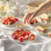 Easy picnic food ideas for two with romantic finger foods, fresh fruit, cheese, and quick snacks on a blanket outdoors.