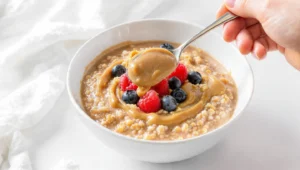 Quick healthy breakfast sweet vs savory options with açaí fruit bowl and avocado egg toast on a wooden table.