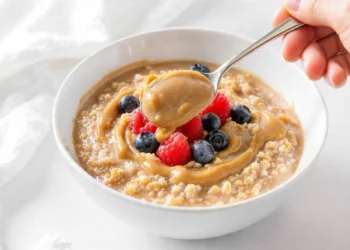 Quick healthy breakfast sweet vs savory options with açaí fruit bowl and avocado egg toast on a wooden table.